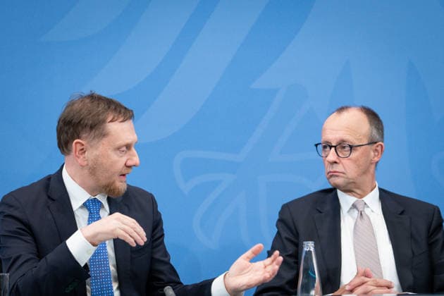 Press conference following the Conference of Minister Presidents at the Federal Chancellery Michael Kretschmer CDU Minister President of Saxony speaks to Federal Chancellor Friedrich Merz CDU at the press conference following the consultations at the Conference of Minister Presidents at the Federal Chancellery, Berlin 04 12 2025 Berlin Berlin Germany