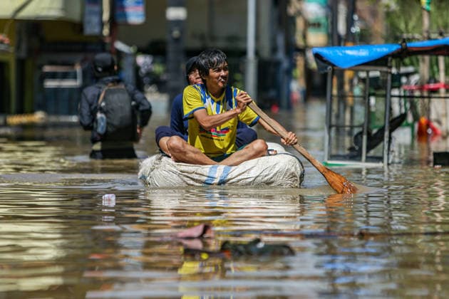 December 5, 2025, Bandung Regency, West Java, Indonesia: A resident rows his makeshift boat during flooding in Dayeuhkolot, Bandung Regency, West Java, on December 5, 2025. The Bandung Regency Disaster Management Agency (BPBD) stated that at least 34,000 people from three subdistricts in Bandung Regency were affected by flooding ranging from 10 cm to 150 cm high due to heavy rainfall and the overflowing of the Citarum River. Bandung Regency Indonesia - ZUMAp283 20251205_zip_p283_008 Copyright: xClaudioxPramanax