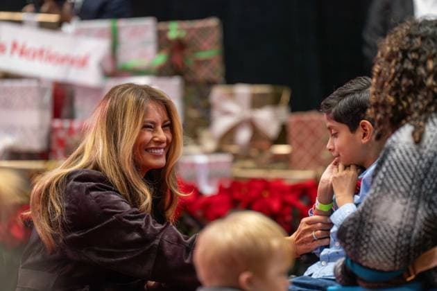 December 5, 2025, Washington, District Of Columbia, USA: First Lady MELANIA TRUMP smiles and holds a child as she speaks with him and his parent during her visit to the ChildrenÃ¢â‚¬â ¢s National Hospital. Washington USA - ZUMAs365 20251205_znp_s365_009 Copyright: xJoeyxSussmanx