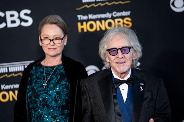 Kennedy Center Honoree Peter Criss of Kiss and his wife, Gigi Criss, arrive on the red carpet for the 48th annual Kennedy Center Honors at the Kennedy Center in Washington DC on Sunday, December 7, 2025. President Donald Trump will host this year s event, which honors songwriter George Strait, actors Michael Crawford and Sylvester Stallone, singer Gloria Gaynor, and the rock band Kiss.  WAP20251207514 BONNIExCASH