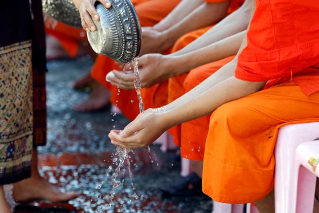 Buddhist ceremony. Worshipper washing the hands of Buddhist monks. Purification ritual. Luang Prabang. Luang Prabang. Laos. Luang Prabang Laos