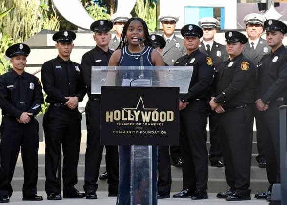 Eniola Taiwo (C) participates in an unveiling ceremony honoring the Los Angeles Fire Department with an Award of Excellence star adjacent to the Hollywood Walk of Fame in Los Angeles on Tuesday, December 2, 2025. Taiwo, 14, wrote a letter to the Hollywood Chamber of Commerce suggesting that firefighters who battled the deadly January fires were worthy of a star on the Hollywood Walk of Fame. The letter precipitated tribute.  LAP2025121215 JIMxRUYMEN