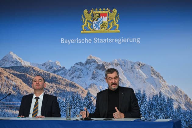 From left Hubert AIWANGER Free Voters, Bavarian Minister of Economic Affairs, Markus SOEDER State Premier of Bavaria and CSU Chairman in front of a wintry Alpine backdrop, press conference of the Bavarian State Government after the cabinet meeting on 16 12 2025 in the Prinz Carl Palais in Munich