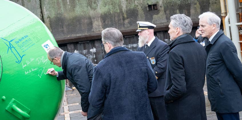 Friedrich Merz, Federal Chancellor of Germany, Bart De Wever, Prime Minister of Belgium, Jan Conrads, Captain of the ship Neuwerk, Dick Schoof, Prime Minister of the Netherlands, Jonas Gahr Store, Minister of State of Norway at the signing of a fairway buoy from left 3rd North Sea Summit 2026 in Hamburg, Germany 3 North Sea S