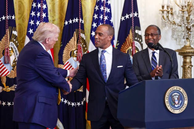 President Donald Trump shakes hands with U.S. Secretary of Housing and Urban Development Eric Turner as Former Housing and Urban Development Secretary Dr. Ben Carson (R) looks on during a reception for Black History Month in the East Room of the White House in Washington, DC on Wednesday, February 18, 2026. The event comes less than two weeks after President Trump s Truth Social account shared a racist video of former President Barack Obama and former First Lady Michelle Obama. WASP20260218111 JIMxLOxSCALZO