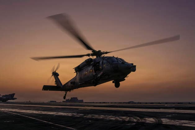 March 6, 2026, Undisclosed Location, United States: A U.S. Navy MH-60S Sea Hawk helicopter, attached to the Chargers of Helicopter Sea Combat Squadron 14, silhouetted by the sunset, takes off from the flight deck of the Nimitz-class aircraft carrier USS Abraham Lincoln during Operation Epic Fury, March 4, 2026, from an undisclosed location. The United States and Israel launched joint strikes on Iran. Undisclosed Location United States - ZUMAp138 20260306_zaa_p138_006 Copyright: xUsxNavy U.S.xNavyx