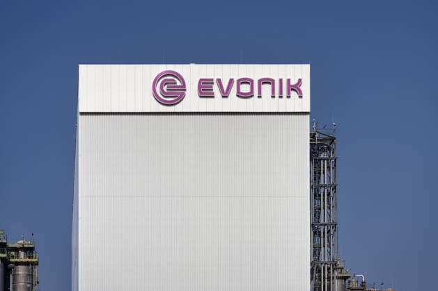 Modernity Industrial plant from Evonik in Wesseling with Company logo at White Facade at beaming blue Sky 1133502036