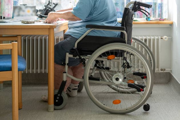 Bavaria, Germany - March 10, 2026: An elderly person in a wheelchair at a table highlights the challenges of everyday care. The image addresses inclusion, accessibility, and the support needed to live with dignity.