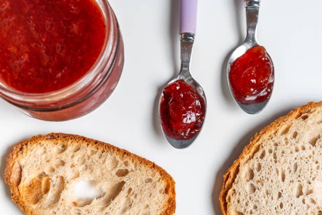 Bavaria, Germany March 31, 2026: Fresh jam is spread on bread with a spoon, symbolizing a classic breakfast where enjoyment, simple ingredients, and a sweet start to the day are at the heart of daily nutrition.