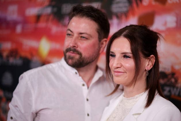 Felix von Jascheroff and his wife Alexandra Sophie von Jascheroff stand on the red carpet before the cinema preview of Kampf der RealityAllstars