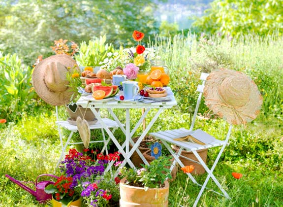 Breakfast for two, served at a Table at bunt blooming Garden on Lake with Sun hats and Hearts, Composing Breakfast for two, served ON a Table in a Colorful Garden blooming With coneflowers and hearts, Composing BLWS745584 Copyright: xblickwinkel C.xLesjakx
