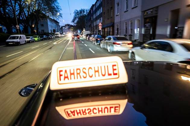 Symbolic picture driving school, evening drive in the city center, urban traffic driving school