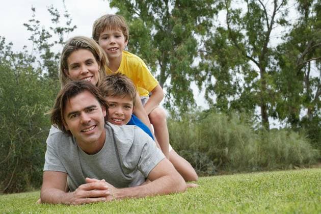 Portrait Of Family Lying On Top Of Each Other In Park - Portrait of a couple with two sons lying on top of each other in park model released Symbolfoto Copyright: xmoodboardx Panthermedia75392178.jpg