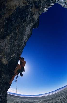 Rock Climber On Cliff Face - Side view of rock climber climbing up a cliff against clear blue sky model released Symbolfoto Copyright: xmoodboardx Panthermedia75326930.jpg