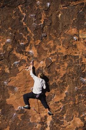 Rock Climber Climbing Up A Cliff - Rear view of rock climber climbing up a cliff model released Symbolfoto Copyright: xmoodboardx Panthermedia75326604.jpg