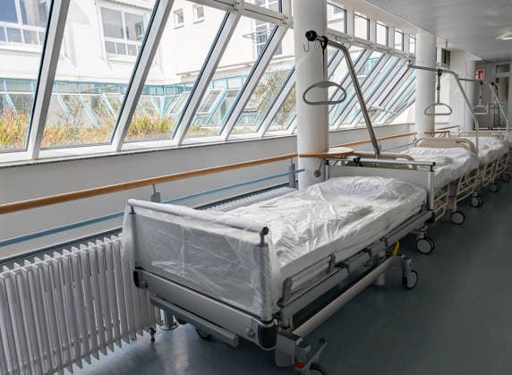 Bavaria, Germany April 16, 2026: Empty hospital beds in a clinic symbolize the nursing crisis and the decline of hospitals. The scene highlights challenges in the healthcare system, such as staff shortages, the need for reform, and ensuring medical care