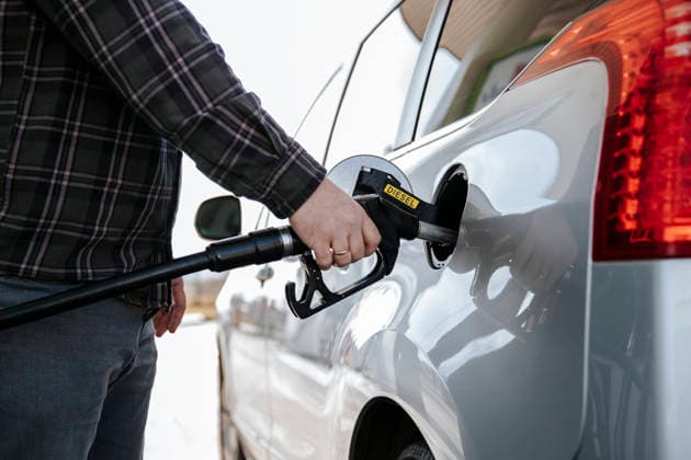 Hand holding diesel nozzle refilling car at gas station model released, Symbolfoto property released, HDF00286