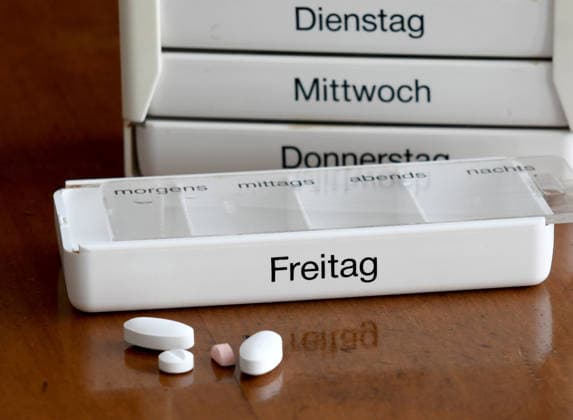 Tablet dispenser with the weekly ration of prescribed tablets The German government is aiming for healthcare reform The expenditure of statutory health insurance funds is growing faster than their expenditure The health insurance funds are to save billions, and the insured are to be asked to pay as well