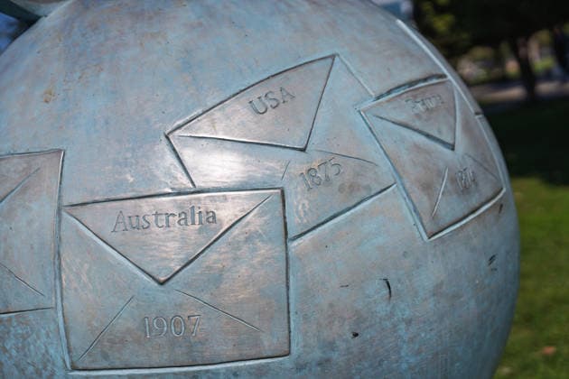 Batumi, georgia 21 april 2026: bronze globe sculpture depicting envelopes and dates representing global post history, creating a symbol for communication and connection Metal globe sculpture showing international communication Copyright: xx Batumi Edit 509