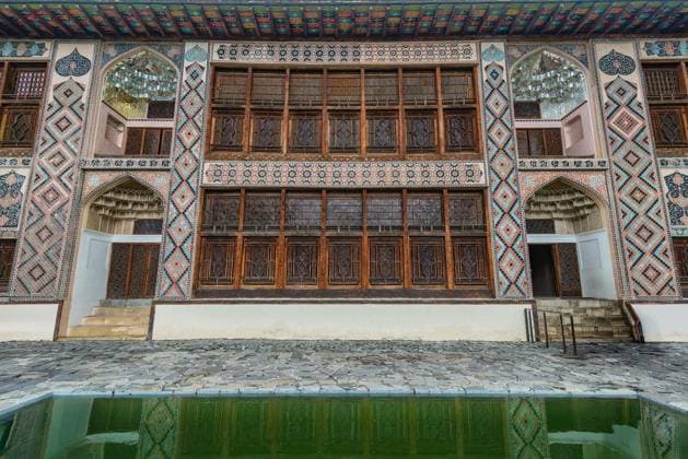 Shaki Khan Palace, Shaki, Azerbaijan. Ornate facade with colorful mosaic tiles, intricate shebeke windows, and a reflecting pool. Historic Azerbaijani architecture Copyright: xkeladawyx Panthermedia102498396.jpg