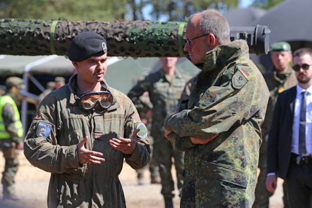 Federal Chancellor Friedrich Merz, right, talks to a first lieutenant of the armored forces in front of a Leopard 2 main battle tank Federal Chancellor Friedrich Merz, right, talks to a first lieutenant of the armored forces in front of a Leopard 2 main battle tank Munster Lower Saxony Germany
