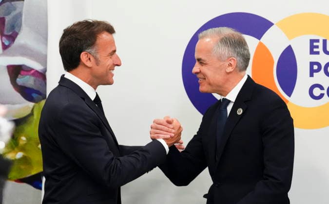 May 4, 2026, Yerevan, Armenia: Prime Minister Mark Carney, right, shakes hands with French President Emmanuel Macron as they arrive to take part in a meeting on the situation in Ukraine during the 8th European Political Community Summit in Yerevan, Armenia, on Monday, May 4, 2026. Yerevan Armenia  - ZUMAc35_ 20260504_zaf_c35_013 Copyright: xSeanxKilpatrickx