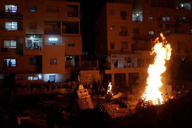 (260505) -- MODI IN, May 5, 2026 -- Ultra-Orthodox Jewish people attend a fire burning ceremony as they celebrate the Jewish holiday of Lag BaOmer in Modi in, Israel, May 4, 2026. (Photo by Xinhua) ISRAEL-MODI IN-LAG BAOMER-CELEBRATION GilxCohenxMagen 