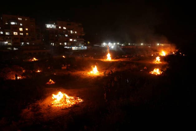 (260505) -- MODI IN, May 5, 2026 -- Ultra-Orthodox Jewish people attend a fire burning ceremony as they celebrate the Jewish holiday of Lag BaOmer in Modi in, Israel, May 4, 2026. (Photo by Xinhua) ISRAEL-MODI IN-LAG BAOMER-CELEBRATION GilxCohenxMagen 