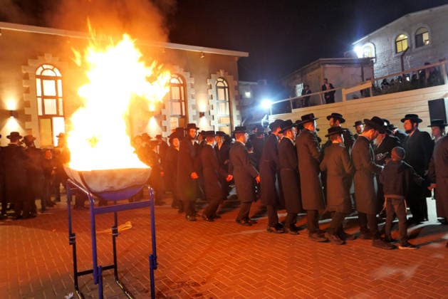 (260505) -- MODI IN, May 5, 2026 -- Ultra-Orthodox Jewish people attend a fire burning ceremony as they celebrate the Jewish holiday of Lag BaOmer in Modi in, Israel, May 4, 2026. (Photo by Xinhua) ISRAEL-MODI IN-LAG BAOMER-CELEBRATION GilxCohenxMagen 