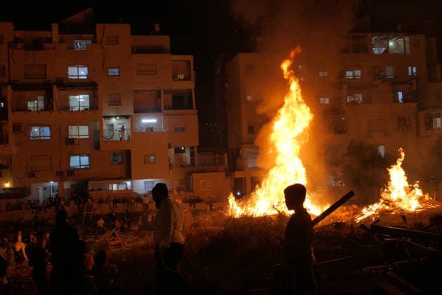(260505) -- MODI IN, May 5, 2026 -- Ultra-Orthodox Jewish people attend a fire burning ceremony as they celebrate the Jewish holiday of Lag BaOmer in Modi in, Israel, May 4, 2026. (Photo by Xinhua) ISRAEL-MODI IN-LAG BAOMER-CELEBRATION GilxCohenxMagen 