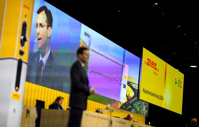 Feature, the development of the DHL share on the screen, in front of it Tobias Meyer CEO, Chairman of the Board of Management during his speech Annual General Meeting of Deutsche Post AG, on 05 05 2026 in Bonn Germany @ World Conference Center