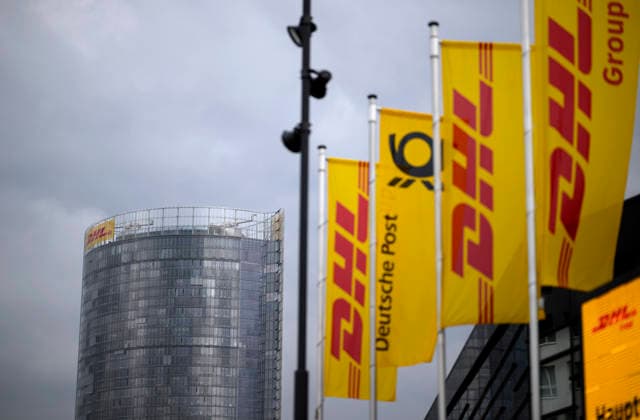 Banners and flags of DHL with logo in front of the HPV in the background the Posttower Annual General Meeting of Deutsche Post AG, on 05 05 2026 in Bonn Germany @ World Conference Center