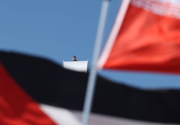 May 5, 2026, Washington, District Of Columbia, USA: Activist Guido Reichstadter sits atop the Frederick Douglass Memorial Bridge as protesters below hold Iranian and Palestinian flags in Washington DC, USA, on May 05, 2026. Reichstadter climbed onto the bridge on May 1 and has remained there in protest of what he described as the Trump regime s war in Iran and against AI development. Washington USA - ZUMAs337 20260505_znp_s337_010 Copyright: xGentxShkullakux
