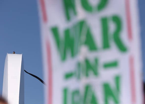 May 5, 2026, Washington, District Of Columbia, USA: Activist Guido Reichstadter sits atop the Frederick Douglass Memorial Bridge as protesters below hold Iranian and Palestinian flags in Washington DC, USA, on May 05, 2026. Reichstadter climbed onto the bridge on May 1 and has remained there in protest of what he described as the Trump regime s war in Iran and against AI development. Washington USA - ZUMAs337 20260505_znp_s337_013 Copyright: xGentxShkullakux