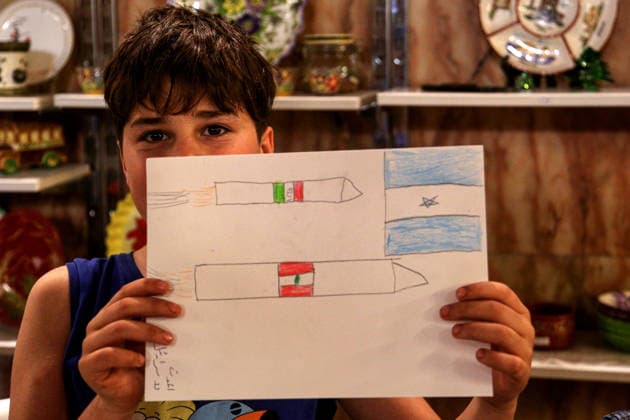 May 5, 2026, Beirut, Beirut, Lebanon: ALI, a displaced boy shows a illustration he did displaying missiles with the Lebanese and Iranian flags and an Israeli pennant during a drawing workshop and an exhibition for dislocated children at a local theatre under the slogan Our Land, Our Identity , showcasing children s artwork about memory, belonging and hope. Despite an announced ceasefire between Israel and pro-Iranian Hezbollah in place since 17 April, the displacement and humanitarian crisis in Lebanon is far from over. Beirut Lebanon  - ZUMAn313 20260505_zip_n313_004 Copyright: xMarwanxNaamanix