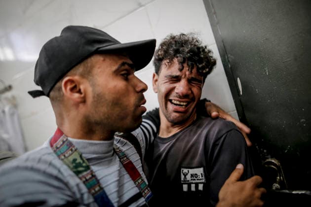 Deadly Strike in Gaza May 5 Getty Images photographer Ahmed Hasaballah stands with a relative while mourning at Al-Shifa Hospital following an Israeli military attack in Gaza City, violating the ceasefire, on May 5, 2026. Gaza Gaza Strip Palestinian Territories Copyright: xSaeedxJarasx