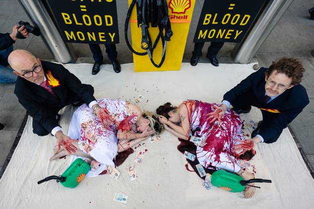 Climate Activists Pour Fake Blood over Protesters at Mock Petrol Pump outside Shell Centre, London, UK 6 May 2026 Activists lie on the ground in front of a mock petrol pump reading Oil Profit$$$ for Oil Bo$$es as they are doused in red liquid resembling blood outside the Shell Centre, London, UK, on 6 May 2026, during a Fossil Free London protest targeting Shell ahead of an expected jump in quarterly profits amid the US-Iran conflict., Credit:Pete Speller Avalon London, United Kingdom  Copyright: xPetexSpellerx xAvalonx 1096871568