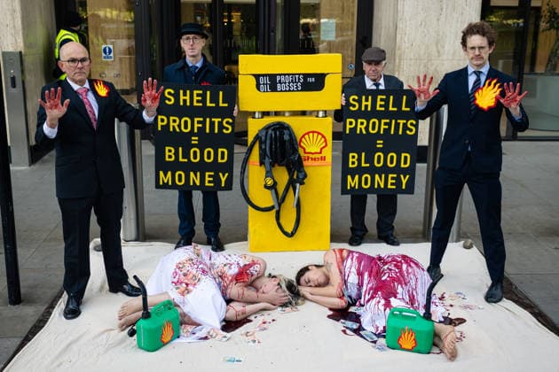 Climate Activists Pour Fake Blood over Protesters at Mock Petrol Pump outside Shell Centre, London, UK 6 May 2026 Activists lie on the ground in front of a mock petrol pump reading Oil Profit$$$ for Oil Bo$$es as they are doused in red liquid resembling blood outside the Shell Centre, London, UK, on 6 May 2026, during a Fossil Free London protest targeting Shell ahead of an expected jump in quarterly profits amid the US-Iran conflict., Credit:Pete Speller Avalon London, United Kingdom  Copyright: xPetexSpellerx xAvalonx 1096871574