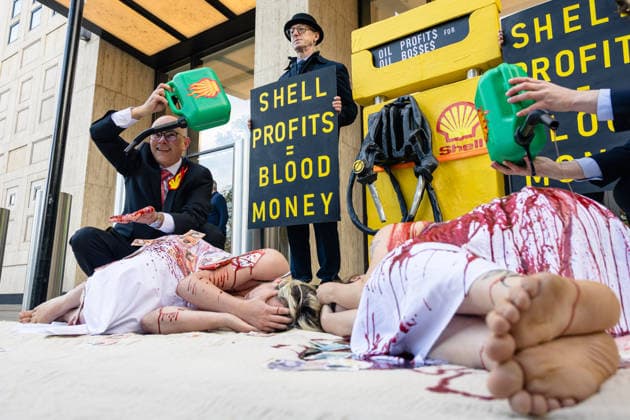 Climate Activists Pour Fake Blood over Protesters at Mock Petrol Pump outside Shell Centre, London, UK 6 May 2026 Activists lie on the ground in front of a mock petrol pump reading Oil Profit$$$ for Oil Bo$$es as they are doused in red liquid resembling blood outside the Shell Centre, London, UK, on 6 May 2026, during a Fossil Free London protest targeting Shell ahead of an expected jump in quarterly profits amid the US-Iran conflict., Credit:Pete Speller Avalon London, United Kingdom  Copyright: xPetexSpellerx xAvalonx 1096871597