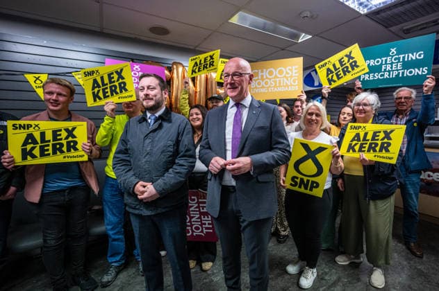First Minister of Scotland John Swinney joins SNP candidate Alex Kerr campaigning in Hamilton - 06 May 2026 First Minister of Scotland John Swinney (front right) poses for a photograph with volunteers campaigning for SNP candidate Alex Kerr. The day before the Scottish parliamentary elections, First Minister of Scotland John Swinney visits Hamilton in South Lanarkshire, the constituency of SNP candidate Alex Kerr to kick off the final day of campaigning by meeting potential voters and owners of local businesses. Hamilton United Kingdom Copyright: xNeilxMiltonx xSOPAxImagesx L1000668