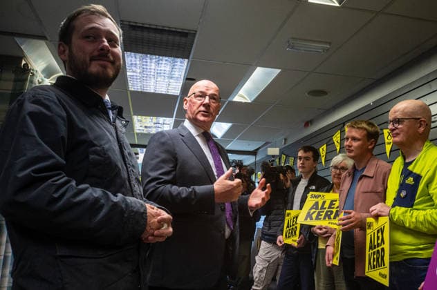 First Minister of Scotland John Swinney joins SNP candidate Alex Kerr campaigning in Hamilton - 06 May 2026 First Minister of Scotland John Swinney (centre) speaks to volunteers campaigning for SNP candidate Alex Kerr. The day before the Scottish parliamentary elections, First Minister of Scotland John Swinney visits Hamilton in South Lanarkshire, the constituency of SNP candidate Alex Kerr to kick off the final day of campaigning by meeting potential voters and owners of local businesses. Hamilton United Kingdom Copyright: xNeilxMiltonx xSOPAxImagesx L1000627