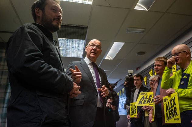 First Minister of Scotland John Swinney joins SNP candidate Alex Kerr campaigning in Hamilton - 06 May 2026 First Minister of Scotland John Swinney (centre) speaks to volunteers campaigning for SNP candidate Alex Kerr. The day before the Scottish parliamentary elections, First Minister of Scotland John Swinney visits Hamilton in South Lanarkshire, the constituency of SNP candidate Alex Kerr to kick off the final day of campaigning by meeting potential voters and owners of local businesses. Hamilton United Kingdom Copyright: xNeilxMiltonx xSOPAxImagesx L1000646