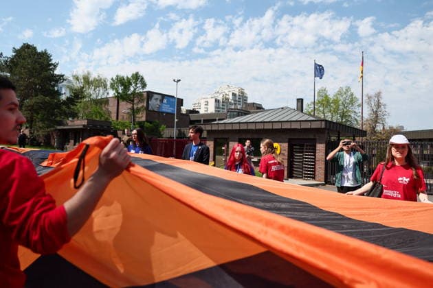 RUSSIA, MOSCOW - MAY 7, 2026: People unfurl a giant St George ribbon during an event titled You Cannot Cancel Truth and Memory! outside the German Embassy in Moscow. Sofya Sandurskaya TASS  92136514