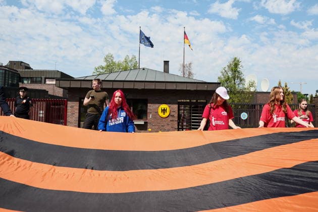 RUSSIA, MOSCOW - MAY 7, 2026: People unfurl a giant St George ribbon during an event titled You Cannot Cancel Truth and Memory! outside the German Embassy in Moscow. Sofya Sandurskaya TASS  92136518