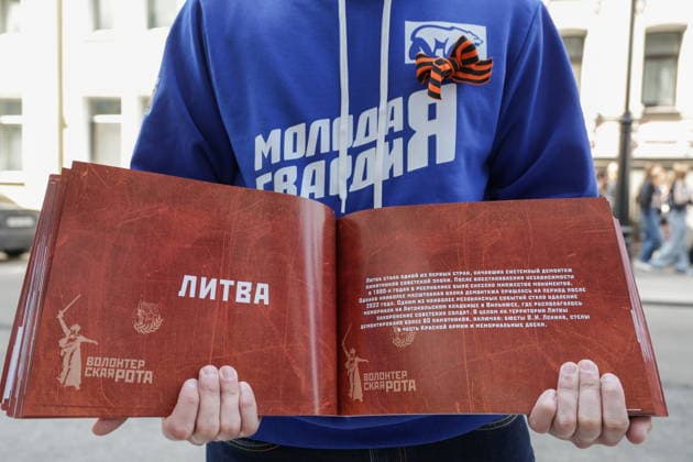 RUSSIA, MOSCOW - MAY 7, 2026: A member of the Young Guard of United Russia holds a catalog of demolished and vandalized monuments and memorial sites during an event titled You Cannot Cancel Truth and Memory! in front of the Lithuanian Embassy Moscow Russia  - ZUMAt113 20260507_zaa_t113_106 Copyright: xMikhailxSinitsynx