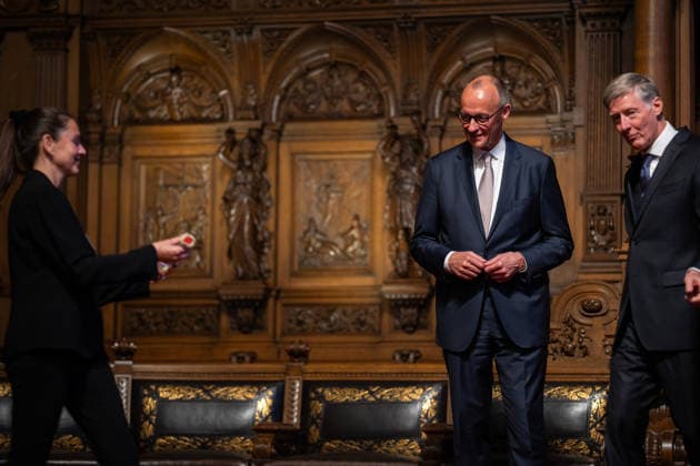 Friedrich Merz, Federal Chancellor, after his speech at Hamburg City Hall, with Harald Vogelsang, President of the Overseas Club and Chairman of the Board of Hamburger Sparkasse, at the presentation of a ship in a bottle as a traditional gift 76 Great Overseas Day in Hamburg, April 2026 Ceremony at Hamburg City Hall, Hamburg Hamburg Germany City Hall