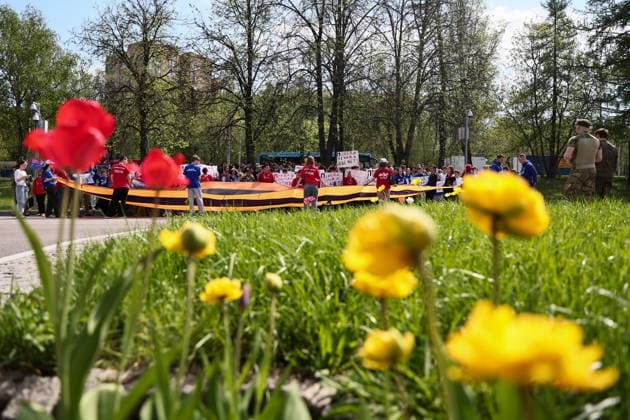 RUSSIA, MOSCOW - MAY 7, 2026: People unfurl a giant St George ribbon during an event titled You Cannot Cancel Truth and Memory! outside the German Embassy in Moscow. Sofya Sandurskaya TASS  92137161