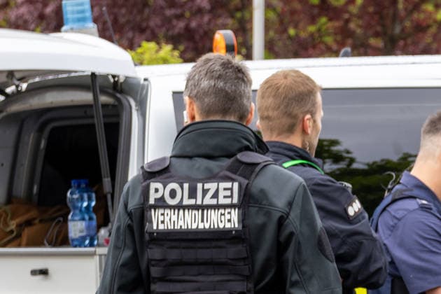 Germany, Bavaria, Augsburg, Pfersee May 7, 2026: Major police operation in the area of Ulrich-Schwarz-Straße in Augsburg Pfersee. A police negotiator is on the scene with other officers during the ongoing operation.