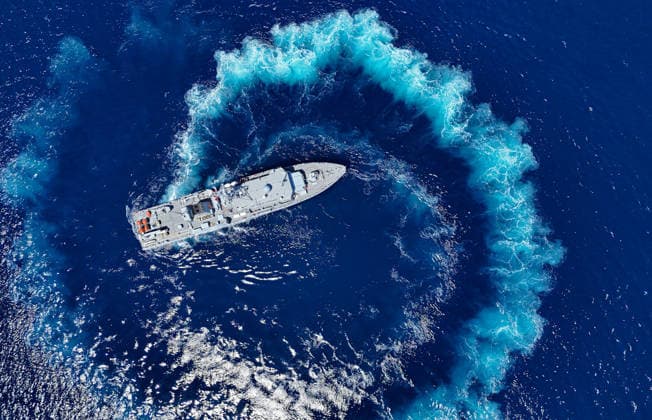 EFES-2026 Exercise in Izmir IZMIR, TURKIYE - MAY 07: An aerial view show Aydin-class mine hunter ship TCG Akcay (M-270) maneuvers in the deep blue sea, creating a large white wake and foam trail during a mine hunting operation as part of the EFES-2026 Exercise in Izmir on May 7, 2026. Conducted by the Turkish Armed Forces (TSK), the tactical exercise involved the detection and successful destruction of maritime mines to ensure safe passage in the region. Berkan Cetin Anadolu Izmir Turkey. Editorial use only. Please get in touch for any other usage.  Copyright: x2026xAnadoluxBerkanxCetinx