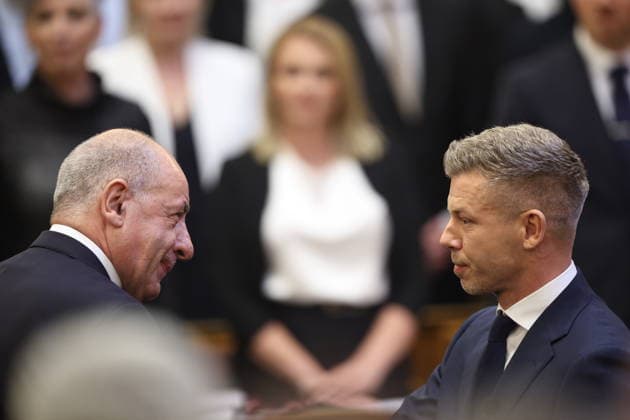 (260509) -- BUDAPEST, May 9, 2026 -- Hungarian President Tamas Sulyok (L) congratulates Peter Magyar on his election as prime minister of Hungary at the House of Parliament in Budapest, Hungary, on May 9, 2026. Peter Magyar, leader of Hungary s Tisza Party, was elected prime minister of Hungary in a vote at the inaugural session of the new parliament on Saturday. A total of 195 out of the 199 members of parliament cast votes, with 140 in favor, 54 against and 1 abstentions. Magyar secured the required majority to be elected prime minister, marking the start of his four-year term. In the parliamentary elections held on April 12, the Tisza Party, led by Magyar, defeated the ruling Fidesz-KDNP coalition led by Viktor Orban, winning 141